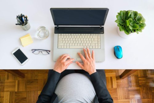 A pregnant person searching for fitness resources on the internet. 
